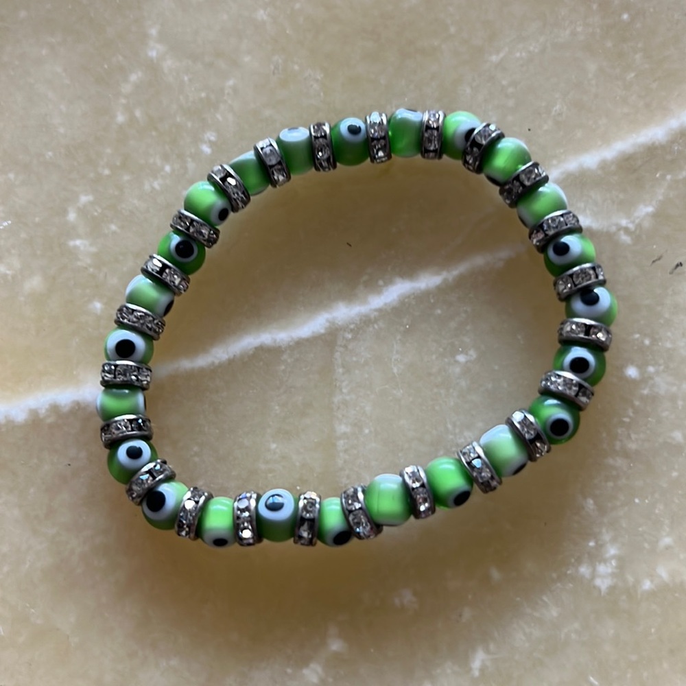 Green stretchy evil eye bracelet.